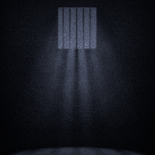 A small, dank, dark prison cell, shafts of grey light weakly pressing between the bars of its high, tiny window.